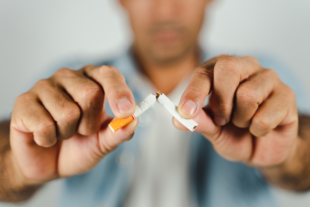 647888ca92d03e3fca3f239f Man hand crushing cigarette