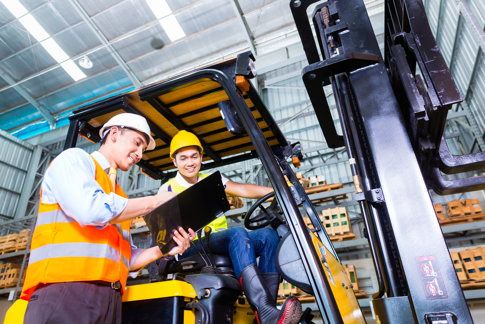 647888ca92d03e3fca3f23ad Asian fork lift truck driver discussing checklist with foreman